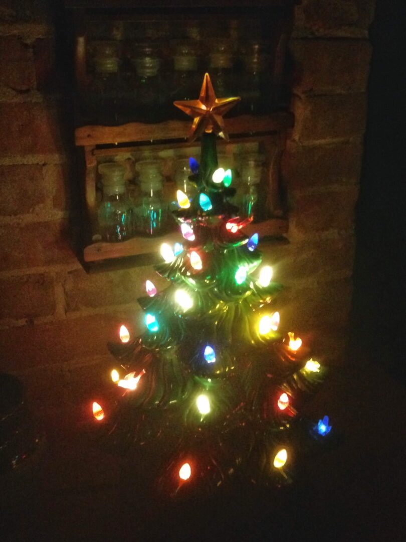 A small Christmas tree decorated with colorful lights and a star on top.
